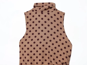 Detailed view of high neck sleeveless top in khaki brown with vintage polka dot pattern