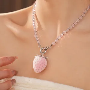 Pink strawberry pendant necklace with faceted beads and a metallic ring clasp for women