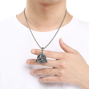 Close-up of Eye of Providence triangular pendant necklace in vintage silver steel