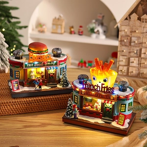 Close-up of lighted resin Burger and French Fries shop miniature models on wood