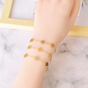 Elegant gold-plated titanium steel bracelet set featuring tree of life and flower charms