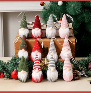Detail of colorful knitted Christmas gnome ornaments in a cozy holiday setting