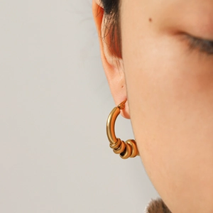 Elegant gold stainless steel hoop earrings with multiple sliding ring charms for women