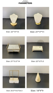 Detailed view of gold metal jewelry display stands with beige velvet lining in various sizes