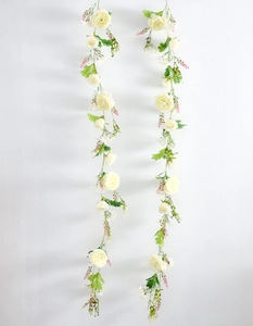 Vertical view of realistic cream white artificial rose vines with silk flower heads