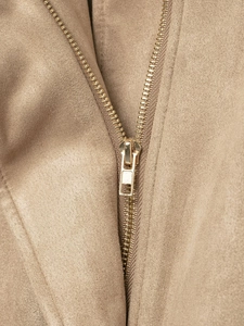 Detailed macro view of khaki suede fabric and high-quality gold metal zipper closure