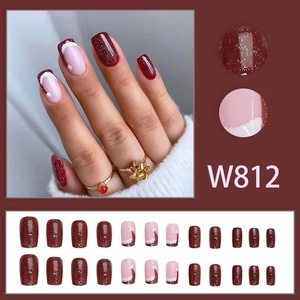 Sparkly dark red and pink press-on nails set with festive glitter and wavy patterns
