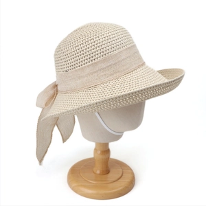 Detail view of breathable straw sun hat with decorative bow and windproof chin strap