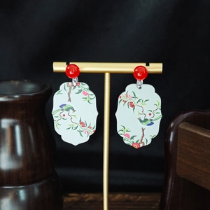 Detail of Chinese style earrings with floral window design and long beaded tassels
