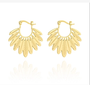 Detailed view of golden leaf-shaped fan earrings with intricate metallic textures
