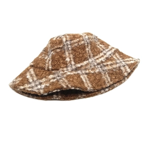 Close-up of brown plaid teddy fleece bucket hat texture with thick warm fuzzy material