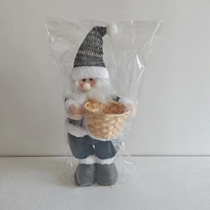 Detail of Nordic Christmas gnome plush toy with grey knit hat and wicker basket