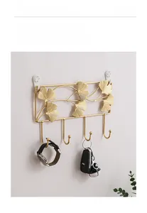 Detail view of golden ginkgo leaf wall hooks for keys and small items storage