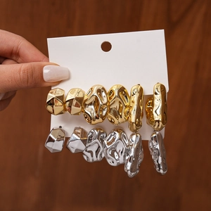 Detail of 6-piece geometric irregular textured stud earrings set in gold and silver