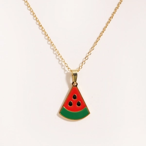 Detailed view of watermelon slice pendant with red enamel and gold chain necklace