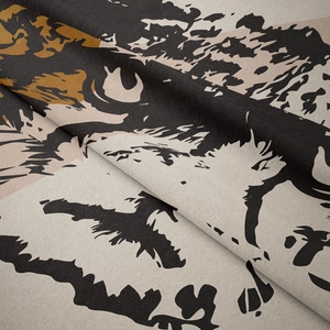Detailed macro view of soft velvet tapestry with abstract animal eye print in earthy tones