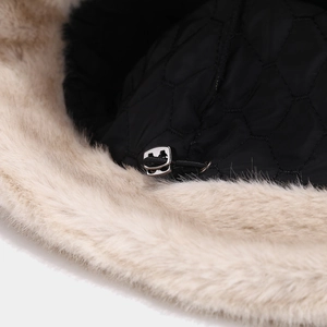 Detail of winter bucket hat showing adjustable drawstring and warm quilted lining texture