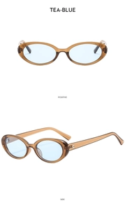Detail of vintage oval sunglasses with translucent tea frames and light blue lenses