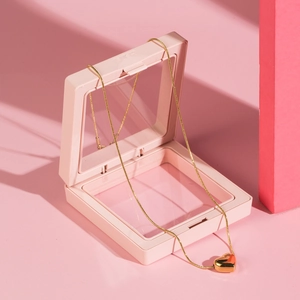 Golden heart necklace displayed in a pink PE film 3D floating suspension jewelry box