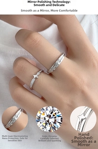 Detail of S925 silver couple rings featuring cubic zirconia stars and textured bands