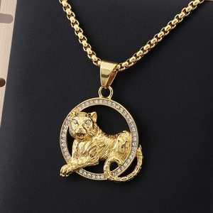 Close-up of hip hop style gold tiger pendant with clear crystals and a sturdy box chain