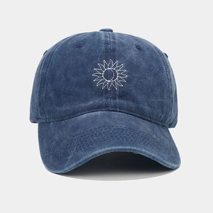 Detailed embroidery of white sun flower pattern on navy blue washed vintage cotton cap