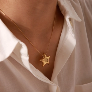 Minimalist 18K gold plated stainless steel star pendant necklace on female model
