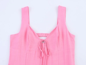 Detail of pink strapless dress featuring lace-up bow and hollow-out texture design