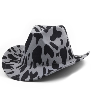 Western cowboy hat with grey cow print pattern and rolled brim shown in a side view