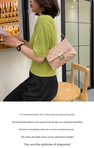 Detail of pink quilted shoulder bag with golden metal chain and twist lock clasp