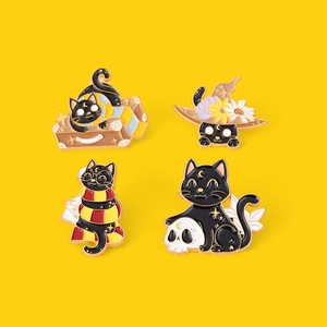 Set of four black cat enamel pins featuring wizard hat and suitcase on yellow background