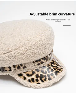 Close-up of lamb wool military cap featuring leopard print brim and metal anchor button