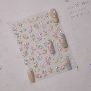 Detailed 3D embossed phoenix and floral nail art stickers with pearl accents on clear sheet