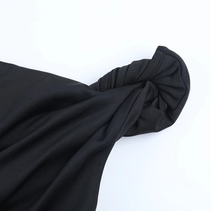 Detail of black slim-fit T-shirt showing unique twisted knot design and knit texture