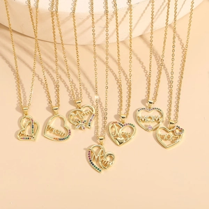 Golden heart necklaces with Mom pendant and colorful zircon stones on beige background