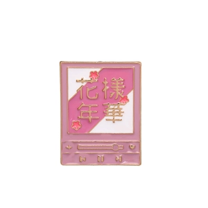 Detail of pink enamel music player pin with Chinese characters and gold finish