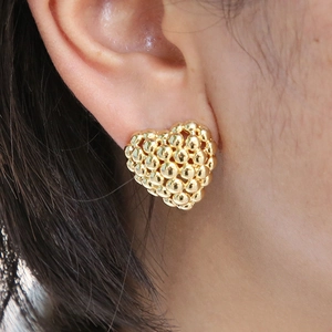 Fashionable 18K gold-plated beaded heart stud earring shown on a female model's ear