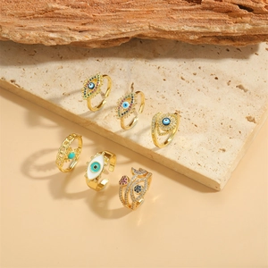Bohemian gold 6-piece evil eye ring set with zircon and enamel on a stone surface