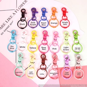 Macro view of multi-color lobster clasp keychains showing various painted metal finishes