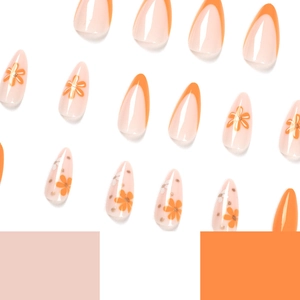 French tip press-on nails featuring orange and white floral designs on almond shape