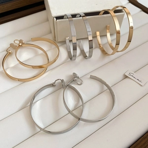 Detailed display of minimalist gold and silver hoop earrings in various sizes and styles