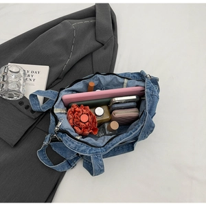 Detailed top view of denim tote bag interior showing spacious capacity and inner pockets
