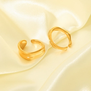 Modern 18K gold plated wavy open rings in fluid organic design on silk fabric