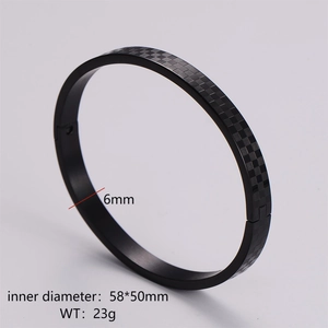 Detail of black checkerboard bangle showing 6mm width and 58x50mm inner diameter