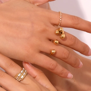 Close-up of stacked 18K gold plated rings with micro-set zircons on female hand