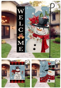 Detail of Christmas snowman garden flag in blue and red linen with Let it Snow text