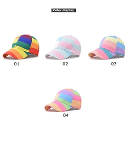 Detail view of four colorful rainbow striped cotton baseball caps in various vibrant colorways