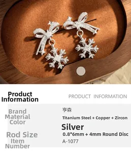 Detailed view of silver bow and snowflake cartilage stud earring made of titanium steel