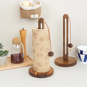 Detail of acacia wood paper towel holder with gravity ball for secure roll storage