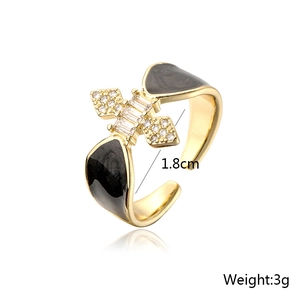 Close-up of 18K gold plated ring with black enamel drip and micro-set zirconia crystals